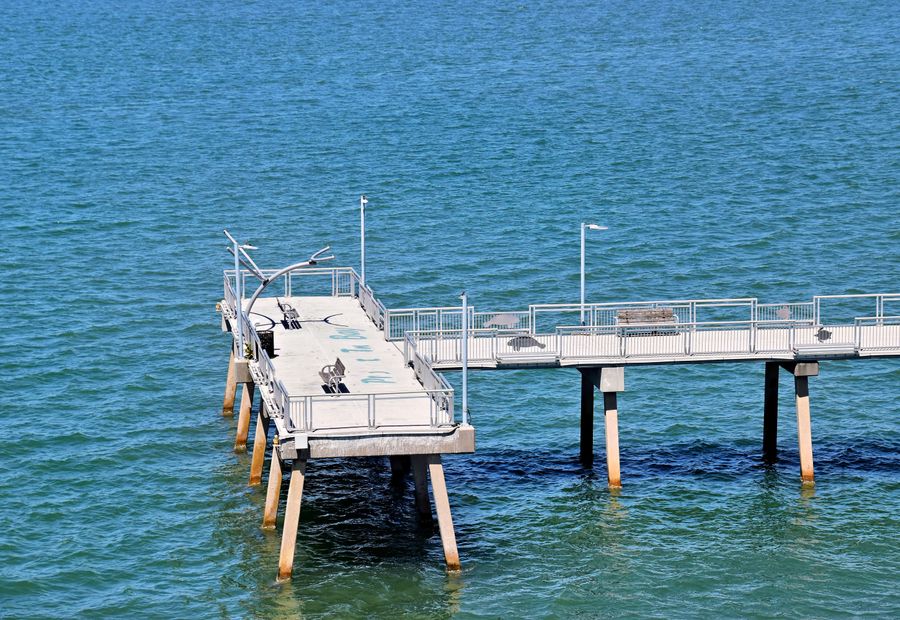 Timber pier on pilings over the turquoise water of St Andrews Bay